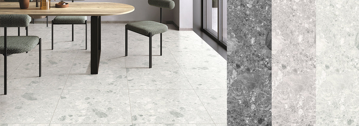 Large format terrazzo look porcelain floor tiles in a dining room with a timber table