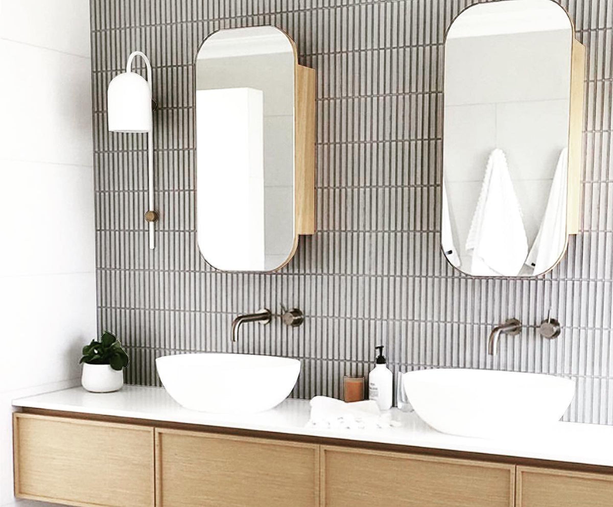 Grey finger mosaic wall with twin vessel basins on a timber vanity