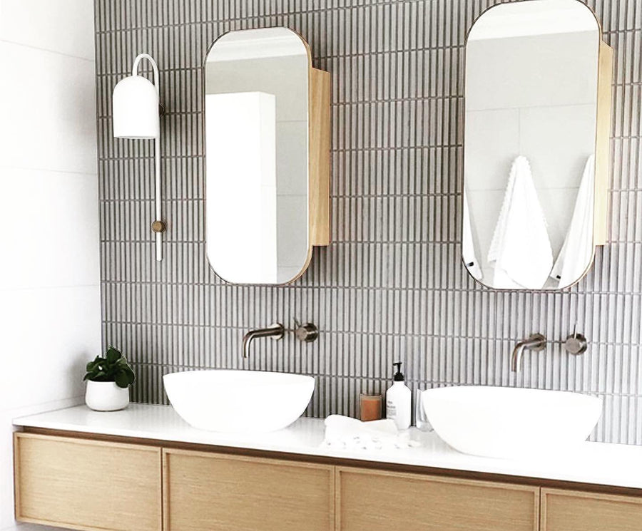 Grey finger mosaic wall with twin vessel basins on a timber vanity