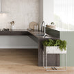 Puro Single Bowl Topmount Care Sink With Drainer in a styled room