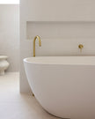 Bloom Floor Bath Spout styled in a bathroom