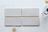 Lodge Light Grey Wavy Edge Matt Ceramic Subway Tiles in a room setting