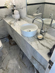 Pisa Gold Polished Marble Look Porcelain Tiles in a room setting