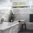 Tribeca Grey Whisper Gloss Porcelain Subway Tiles in a room setting